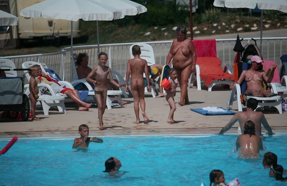 Naturist Afternoon Pool Games pics - A defining feature of naturism is the absence of clothing