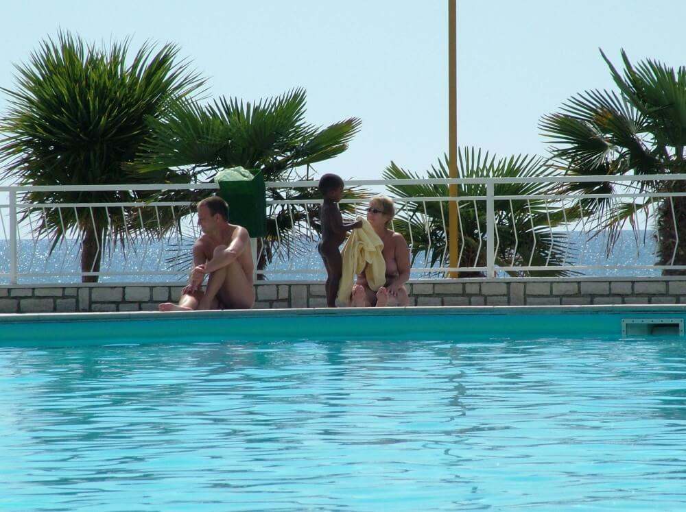 Photo of naturists in an outdoor pool - Sincerity and openness are the foundation of the nudist and naturist lifestyle