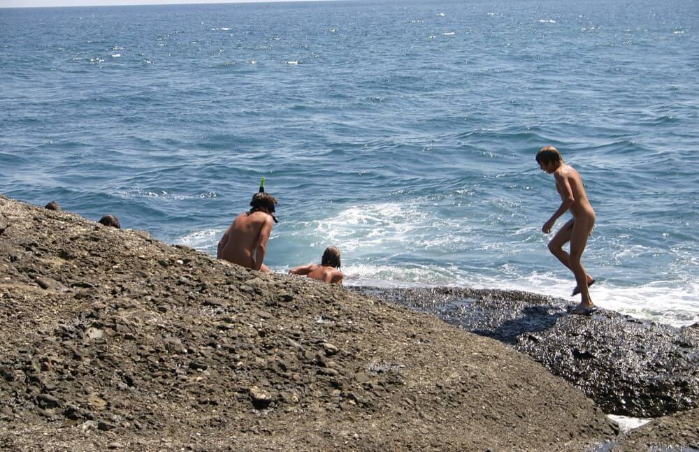 Leaning Against Hit Rocks pics - Health and well-being are enhanced through naturism and nudism